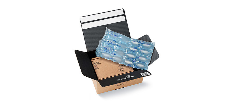 Open cardboard box with protective air cushions